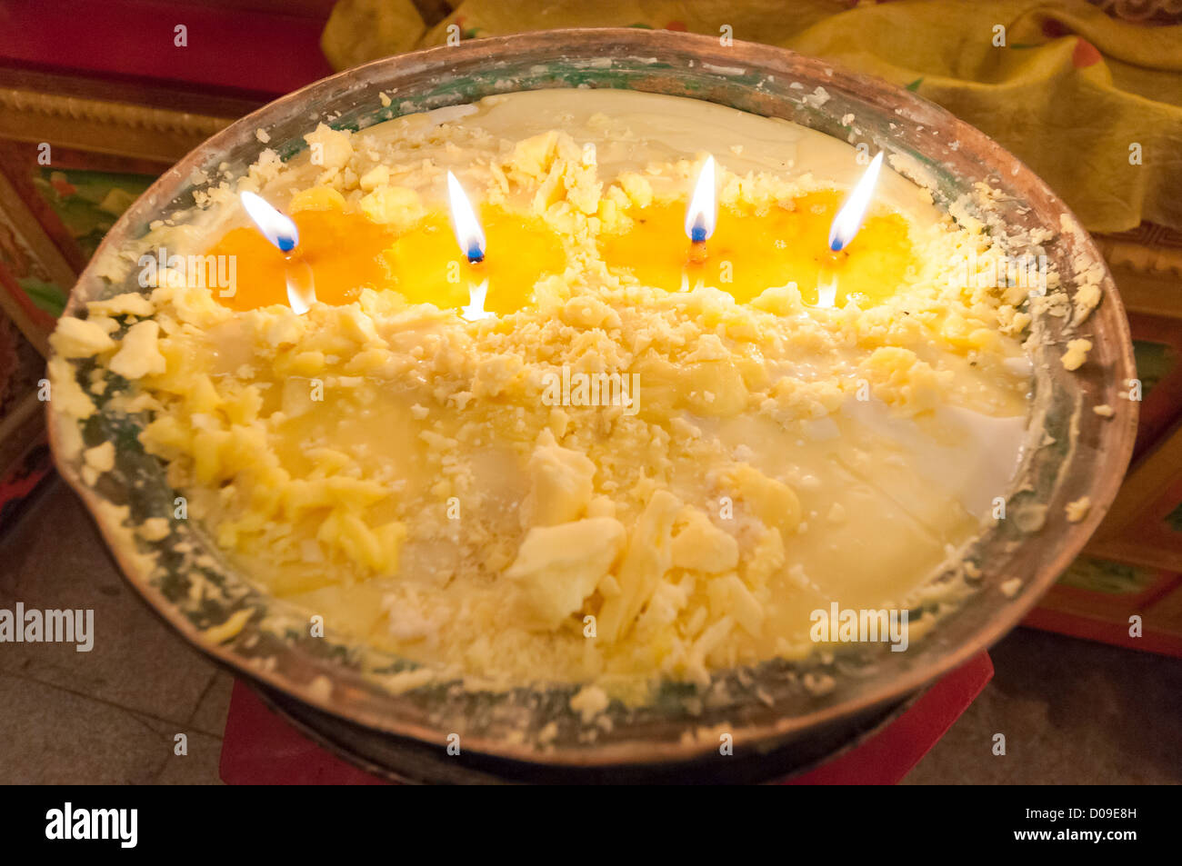 Yak butter candles burn as temple offering, Reting Monastery, Tibet