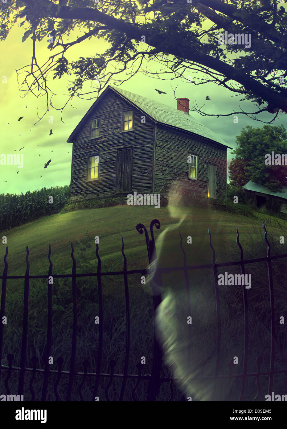 Abandoned haunted house on a hillside with ghost Stock Photo