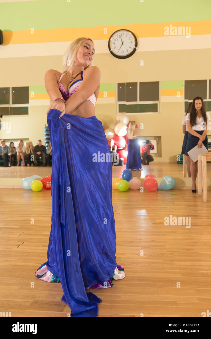 Belly dancer - gorgeous blond with big boobs wearing colorful outfit