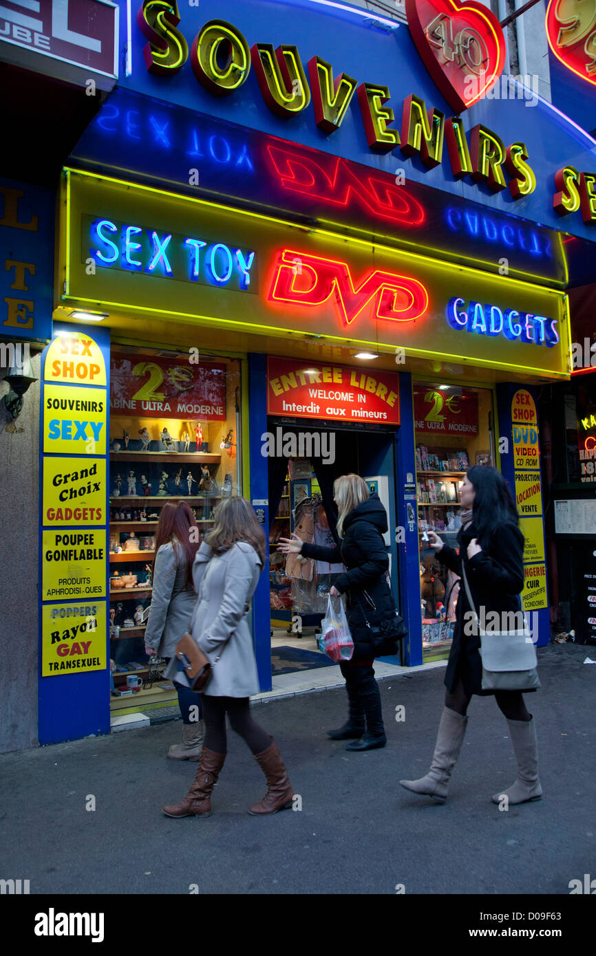 Young women looking at window of sex shops near Place Pigalle in Paris, France Stock Photo