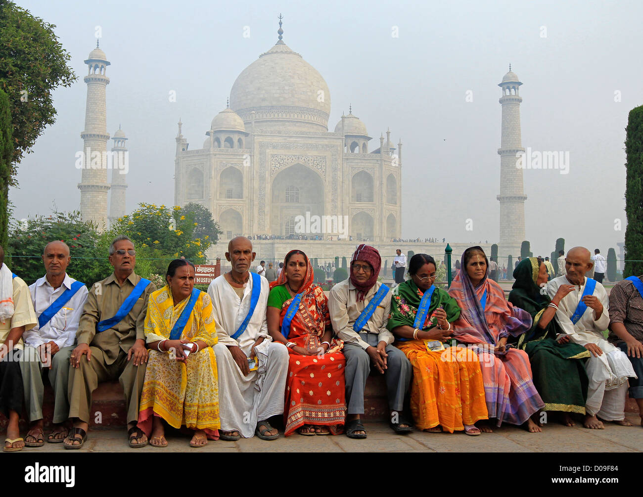 A tour group of members of ISKON Mayapur of the Hare Krishna Movement sit outside the Taj Mahal at Agra in India Stock Photo