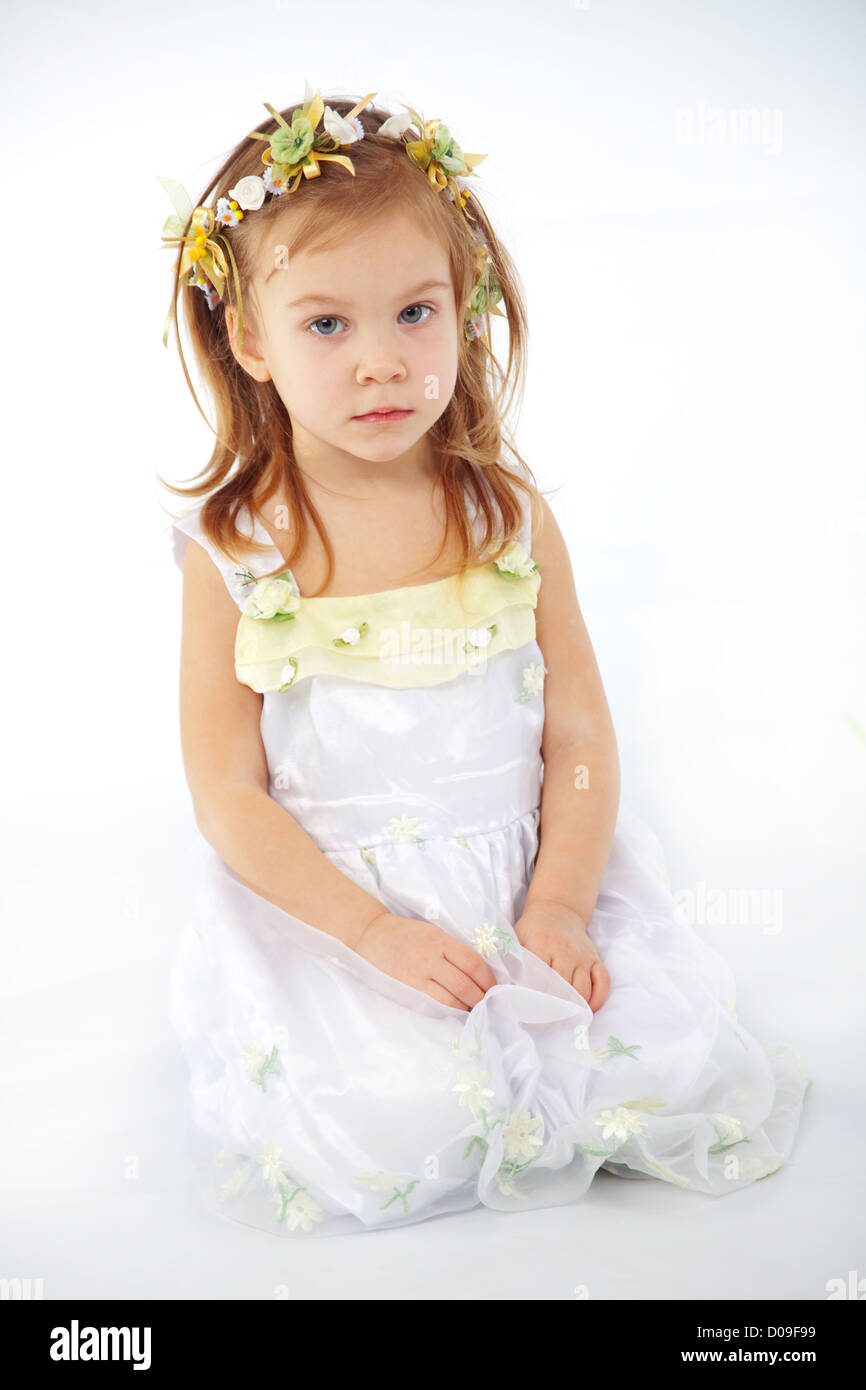 Little girl in spring flower dress on white background Stock Photo - Alamy
