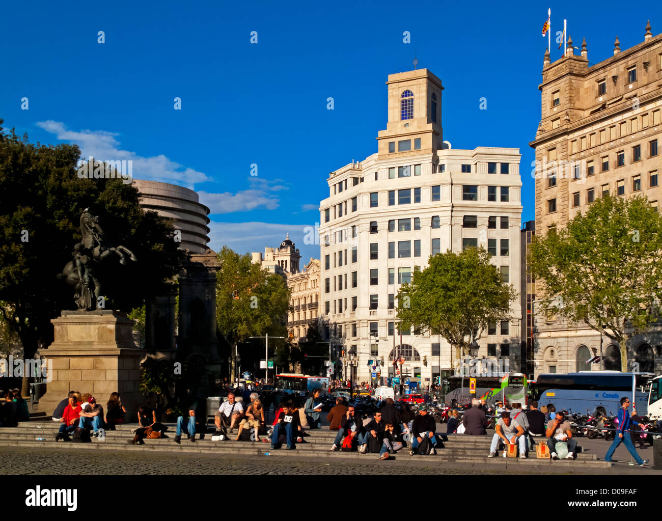 Plaça de Catalunya or Plaza de Cataluña in central Barcelona Catalonia Spain with tourists on steps in foreground Stock Photo