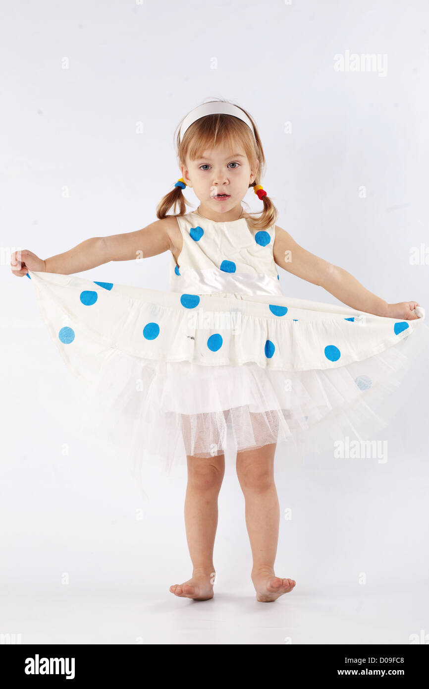 Sweet little girl wearing beautiful dress posing in studio Stock Photo