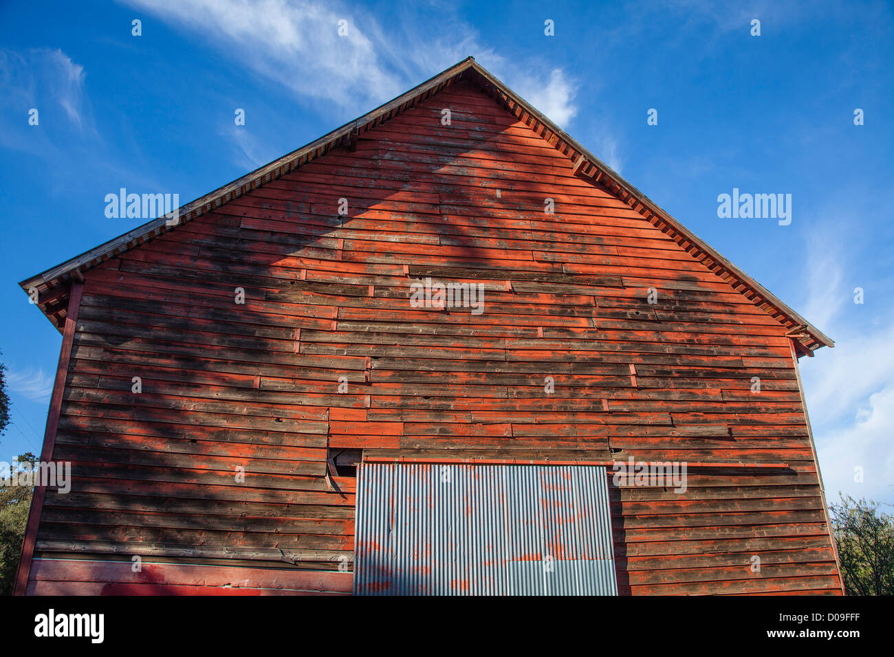 Front Entrance Of Red Barn With Weathered Wooden Siding And Silver