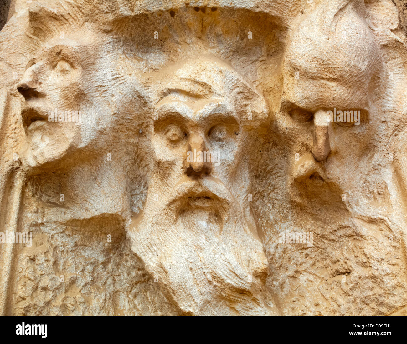 Faces of carved male figures in stone outside Tibidabo basilica church Temple Expiatori del Sagrat Cor Barcelona Catalonia Spain Stock Photo