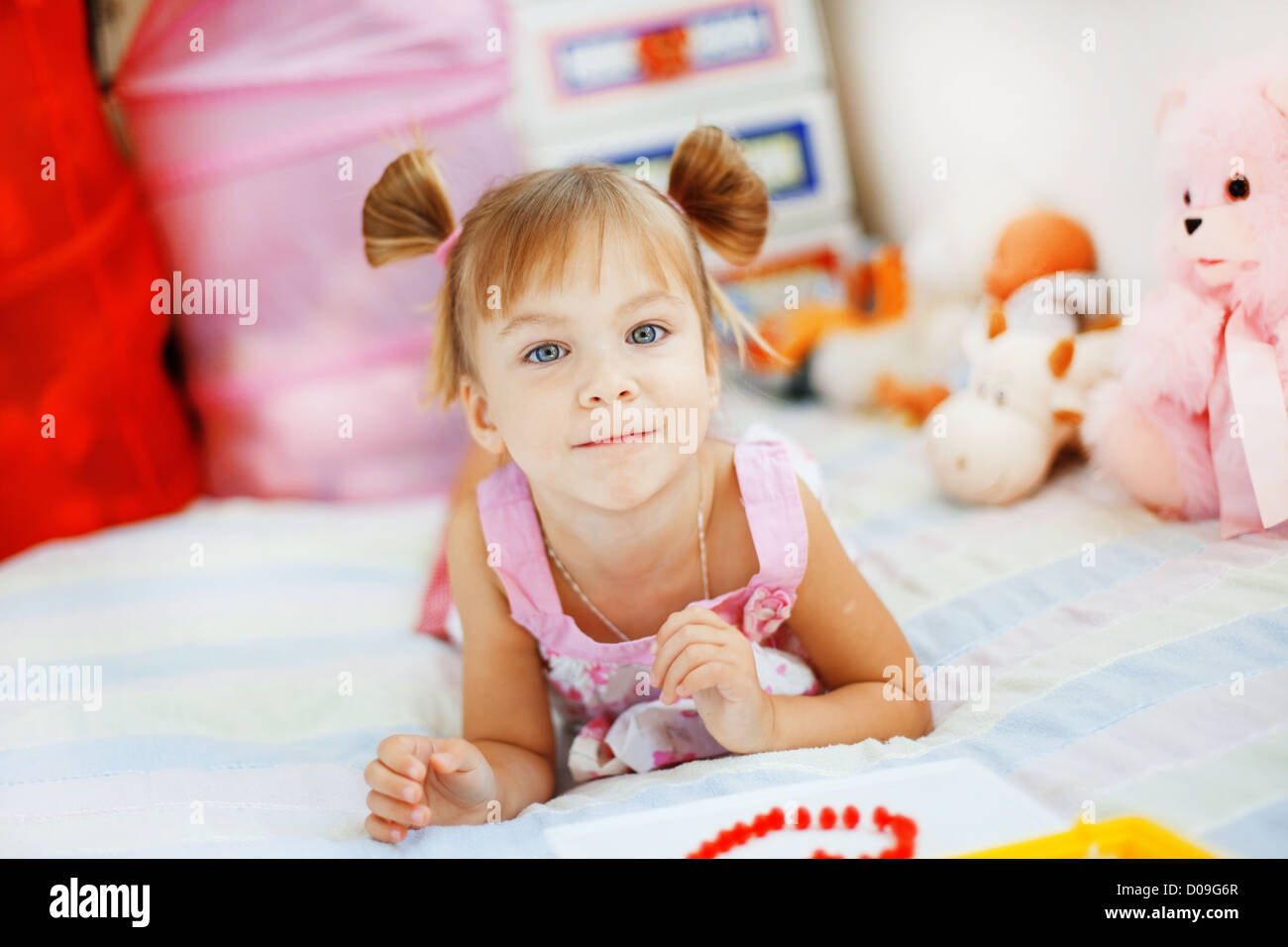 Little girl playing with toys in her nursery Stock Photo - Alamy