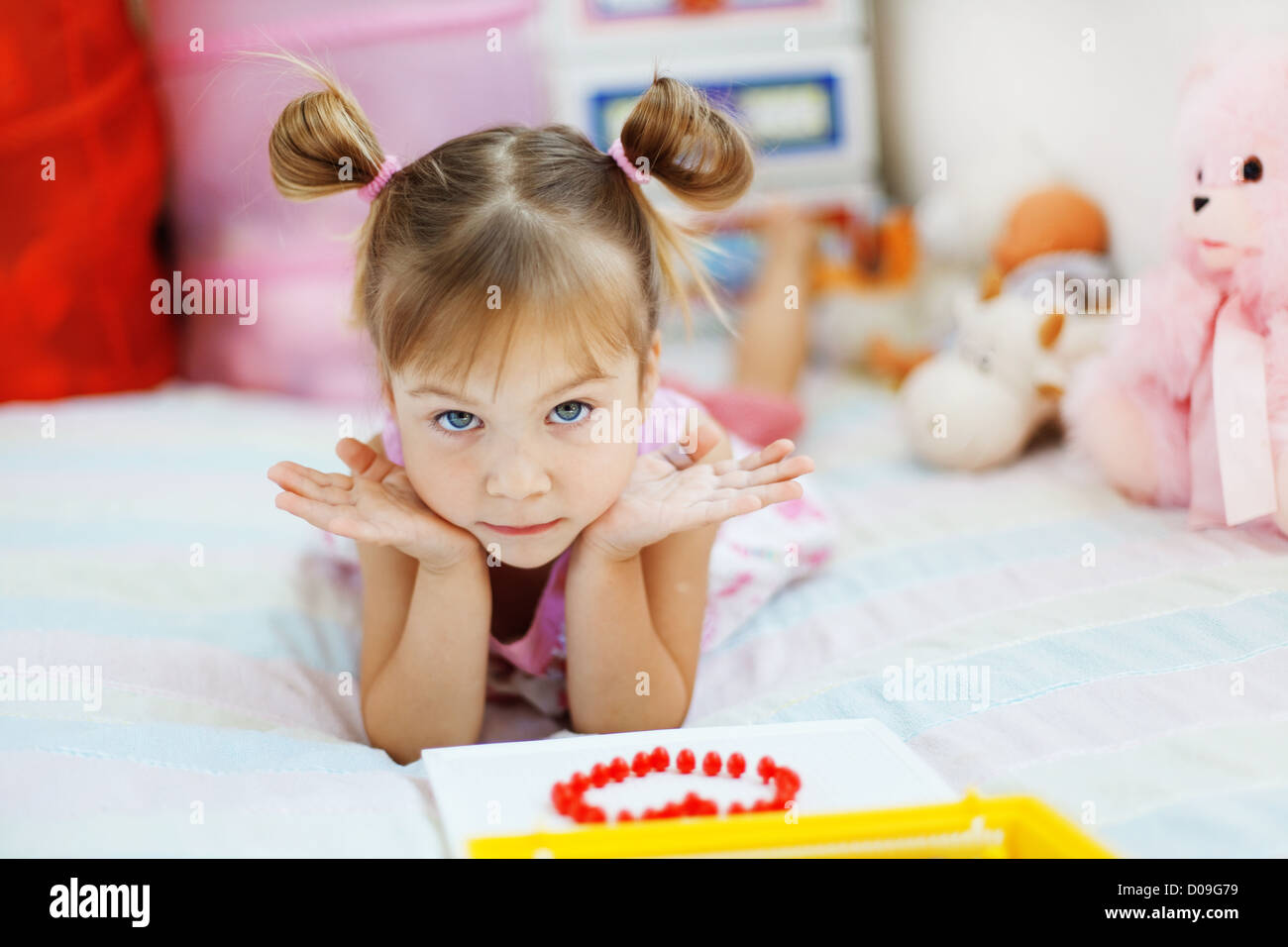 Little girl playing with toys in her nursery Stock Photo - Alamy