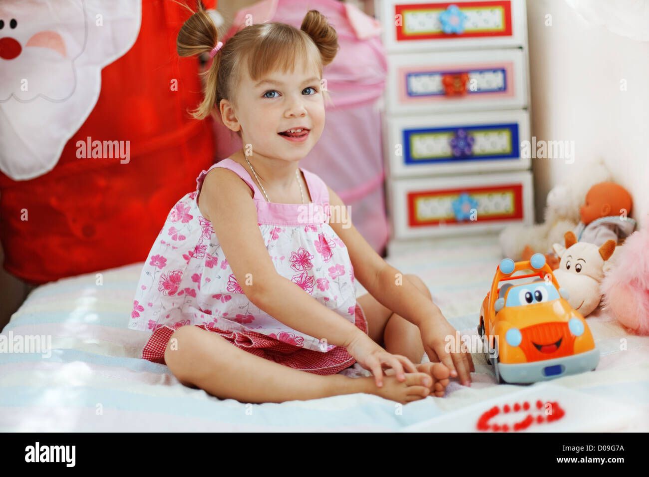 Little girl playing with toys in her nursery Stock Photo - Alamy