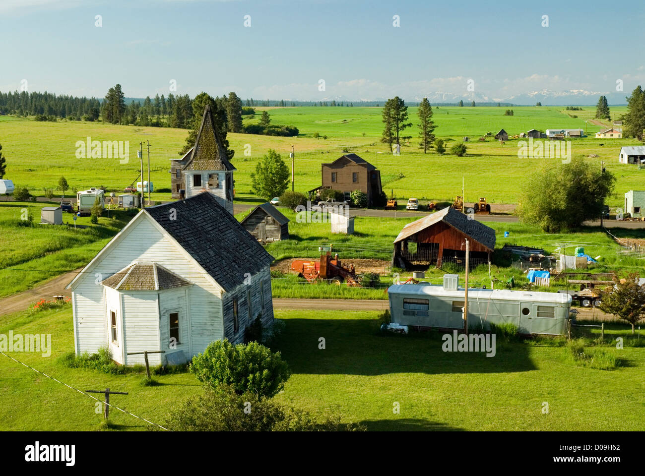 Church and houses in Flora, Oregon, with the Wallowa Mountains in the