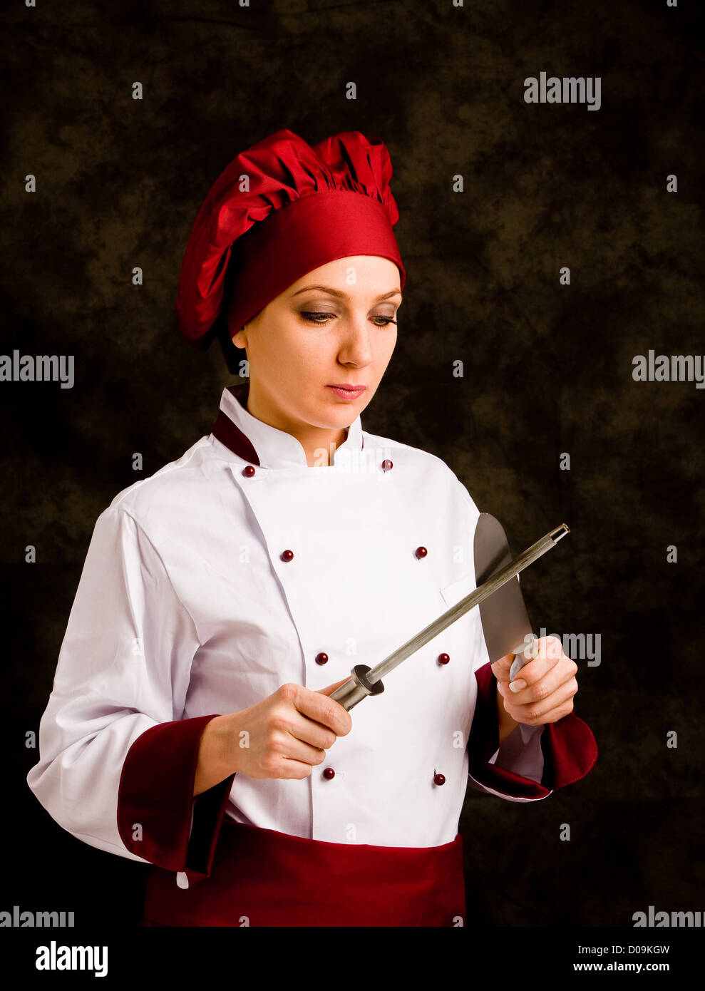 Chef Using Kinife photo of female chef with kinife and sharpener on rural background ...