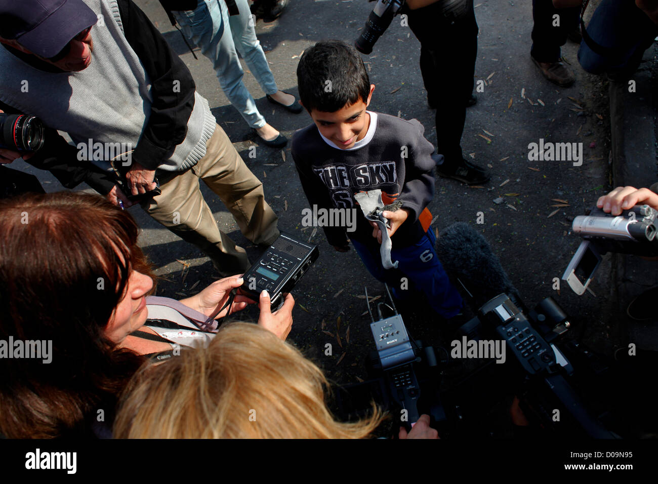 A young Israeli boy shows to members of the media a piece of exploded Qassam rocket that was fired from the Gaza Strip at his house in the southern town of Sderot Israel Stock Photo