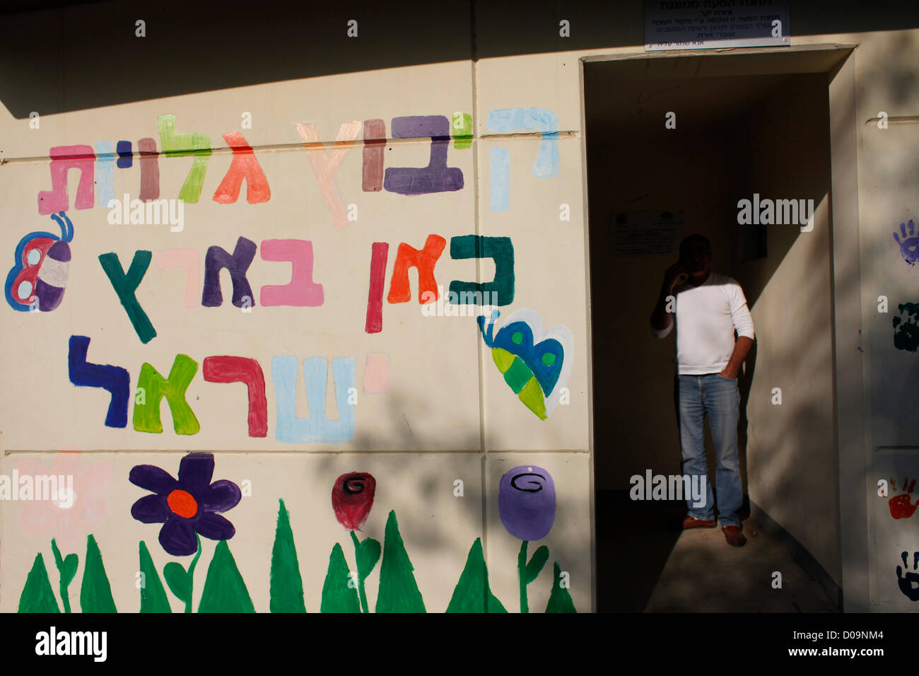 An Israeli civilian inside a decorated freestanding bomb shelter called Migunit in Hebrew in