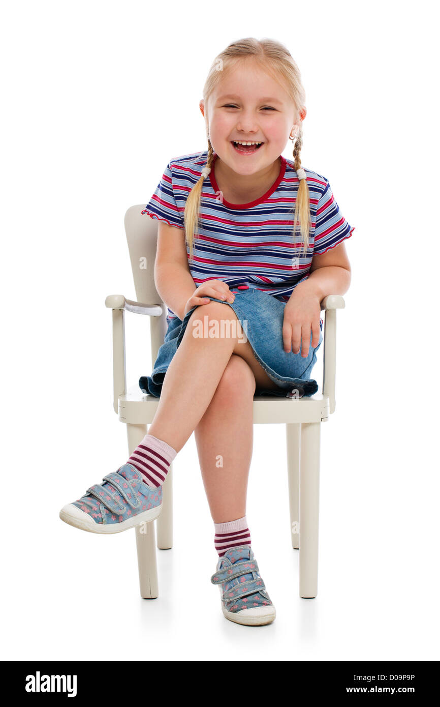 Smiling girl sitting on a chair. Studio shot Stock Photo - Alamy