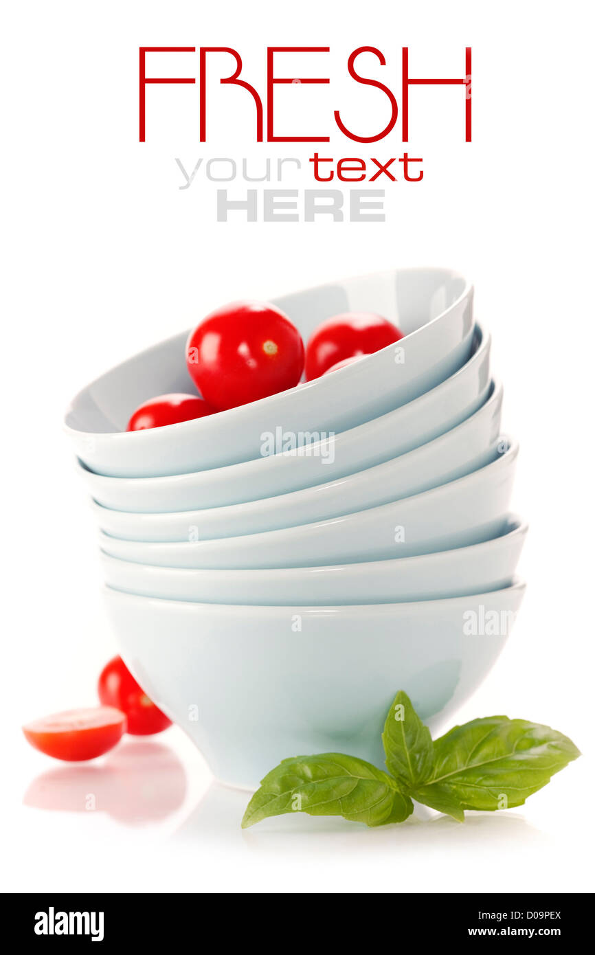 Stack of bowls and tomatoes Stock Photo