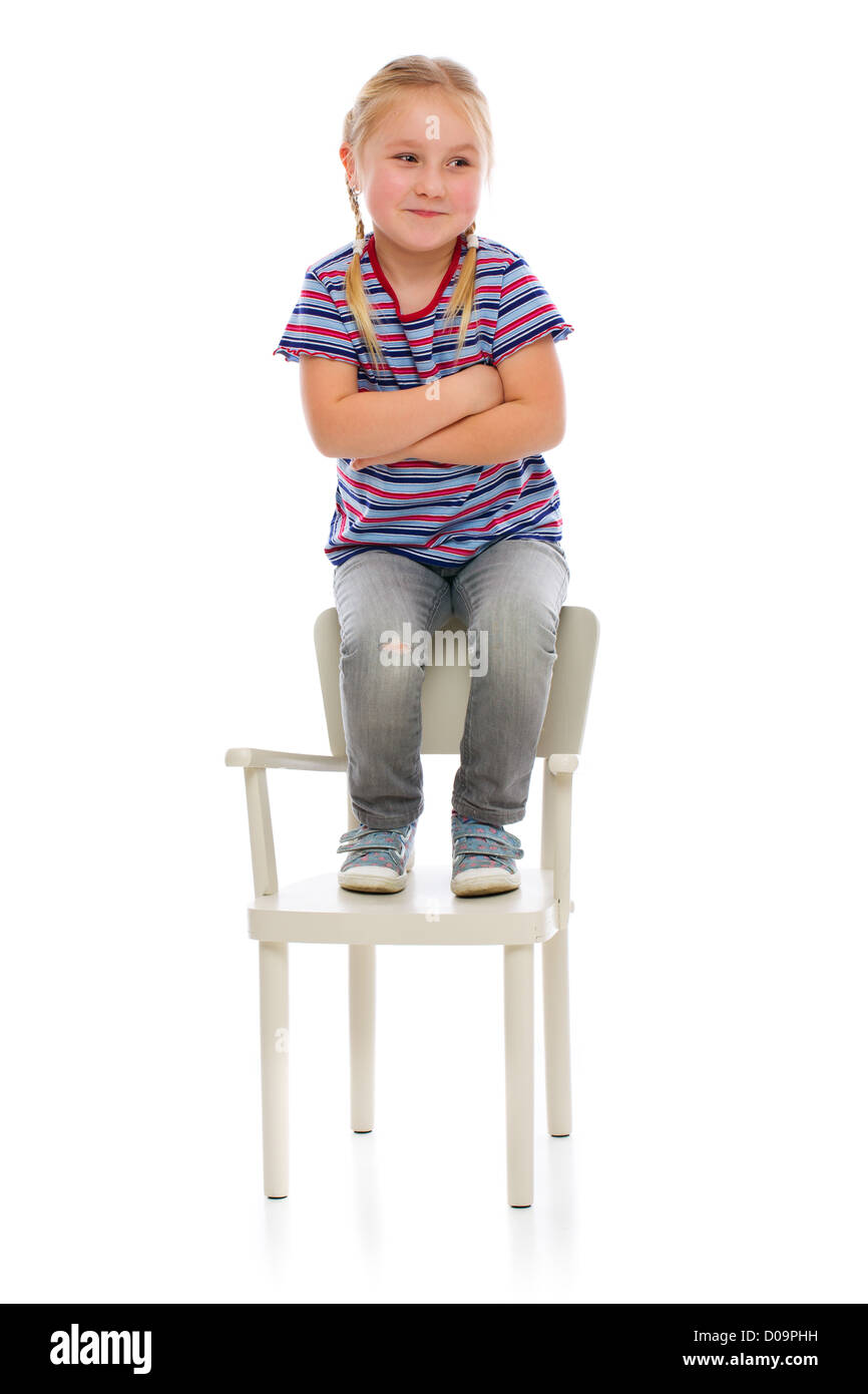 Smiling girl sitting on a chair. Studio shot Stock Photo - Alamy