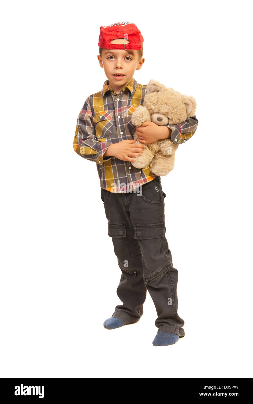 Full length of smiling kid boy holding teddy bear isolated on white ...