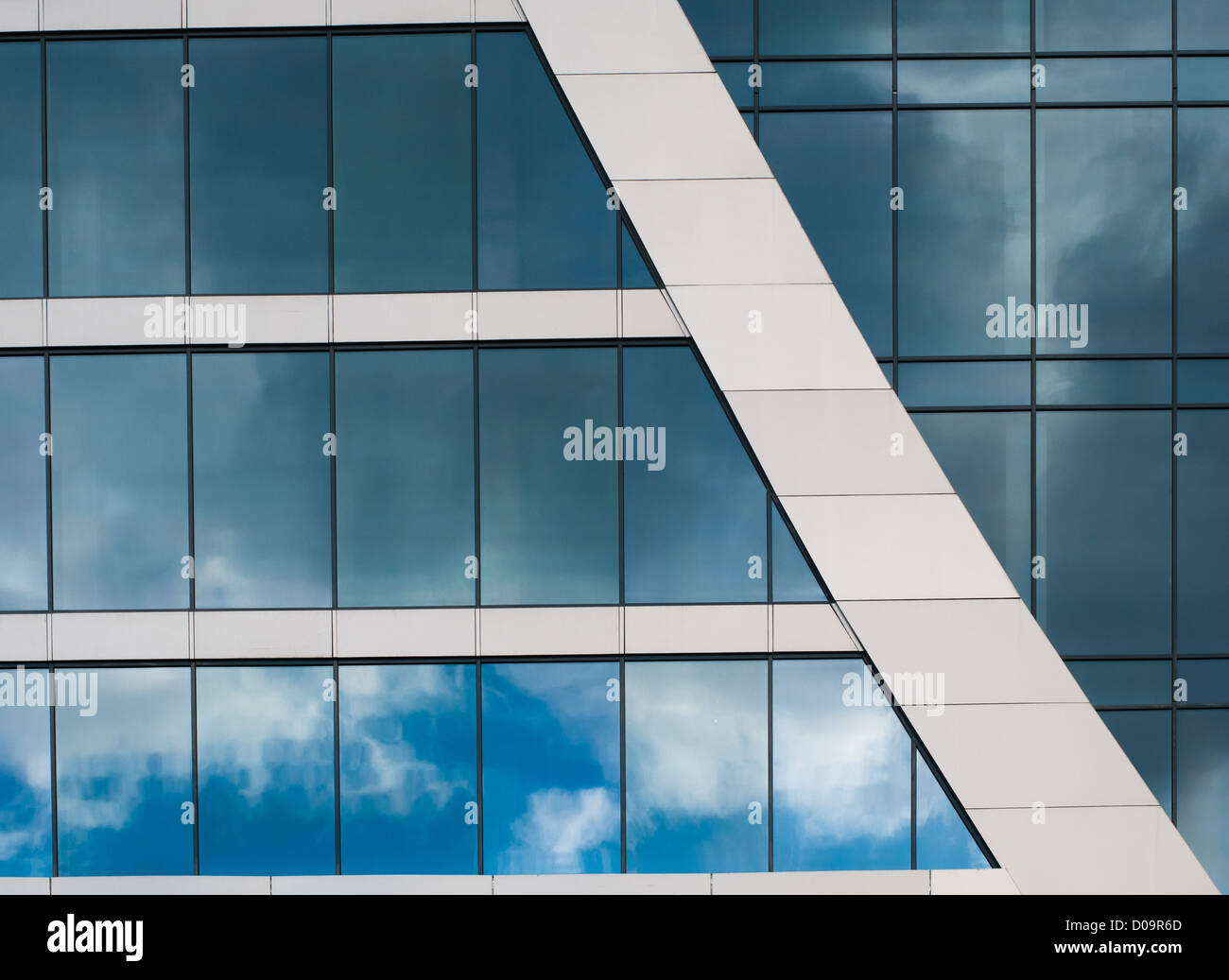 Blue sky reflected in the windows of office building Stock Photo - Alamy