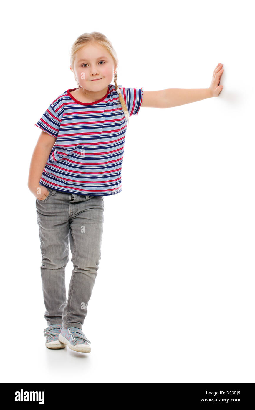 Little girl leaning against a white wall. Studio shot Stock Photo - Alamy
