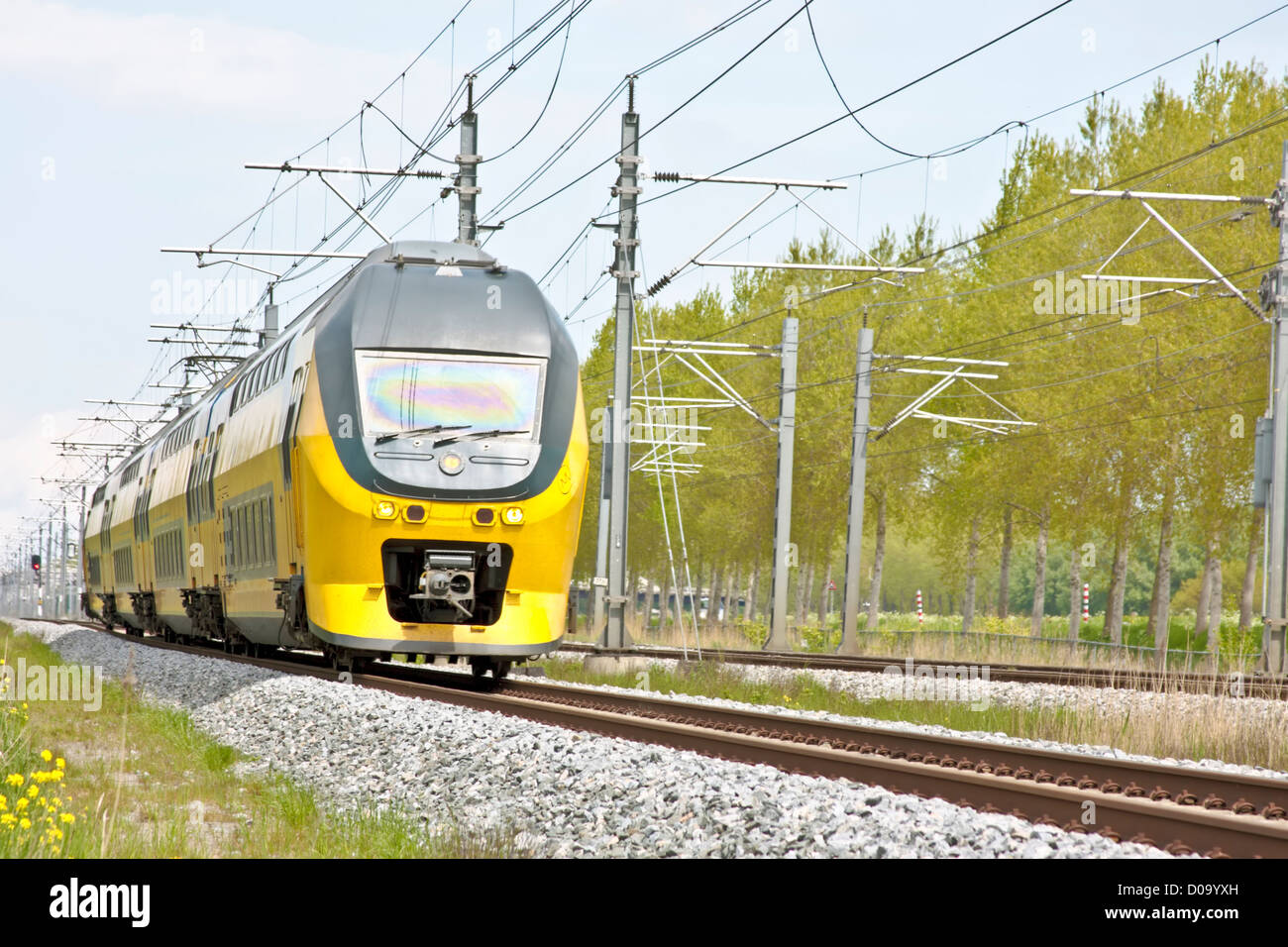 Fast train driving in the countryside from the Netherlands Stock Photo