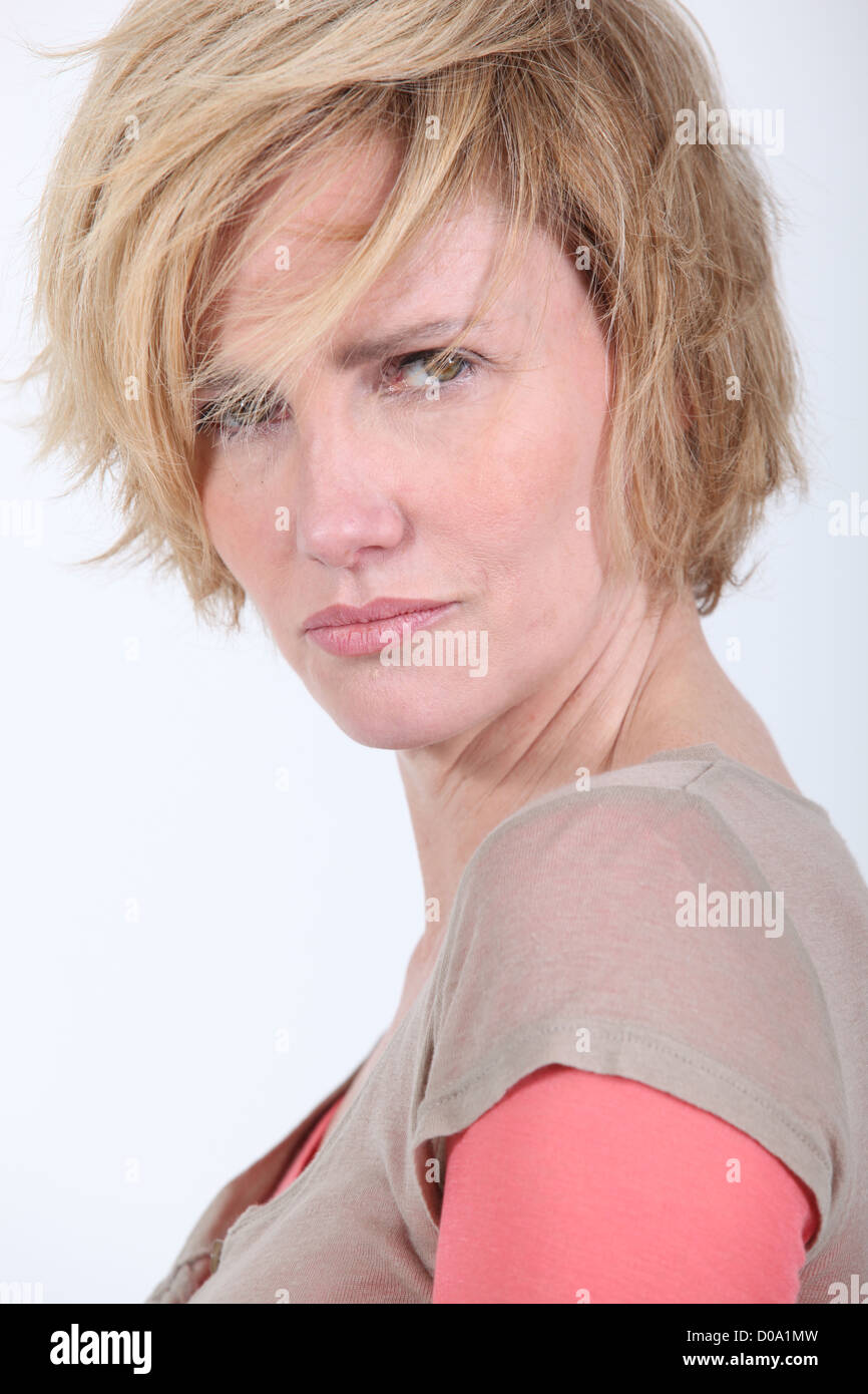 50 Years Old Woman With Tousled Hair Looks Anger Or In Trouble