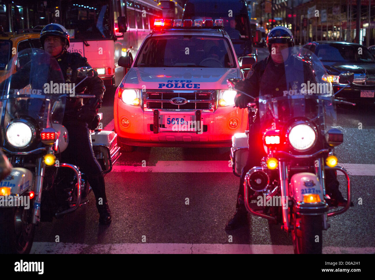A New York Police Department motorcycle patrol team leads a convoy of ...