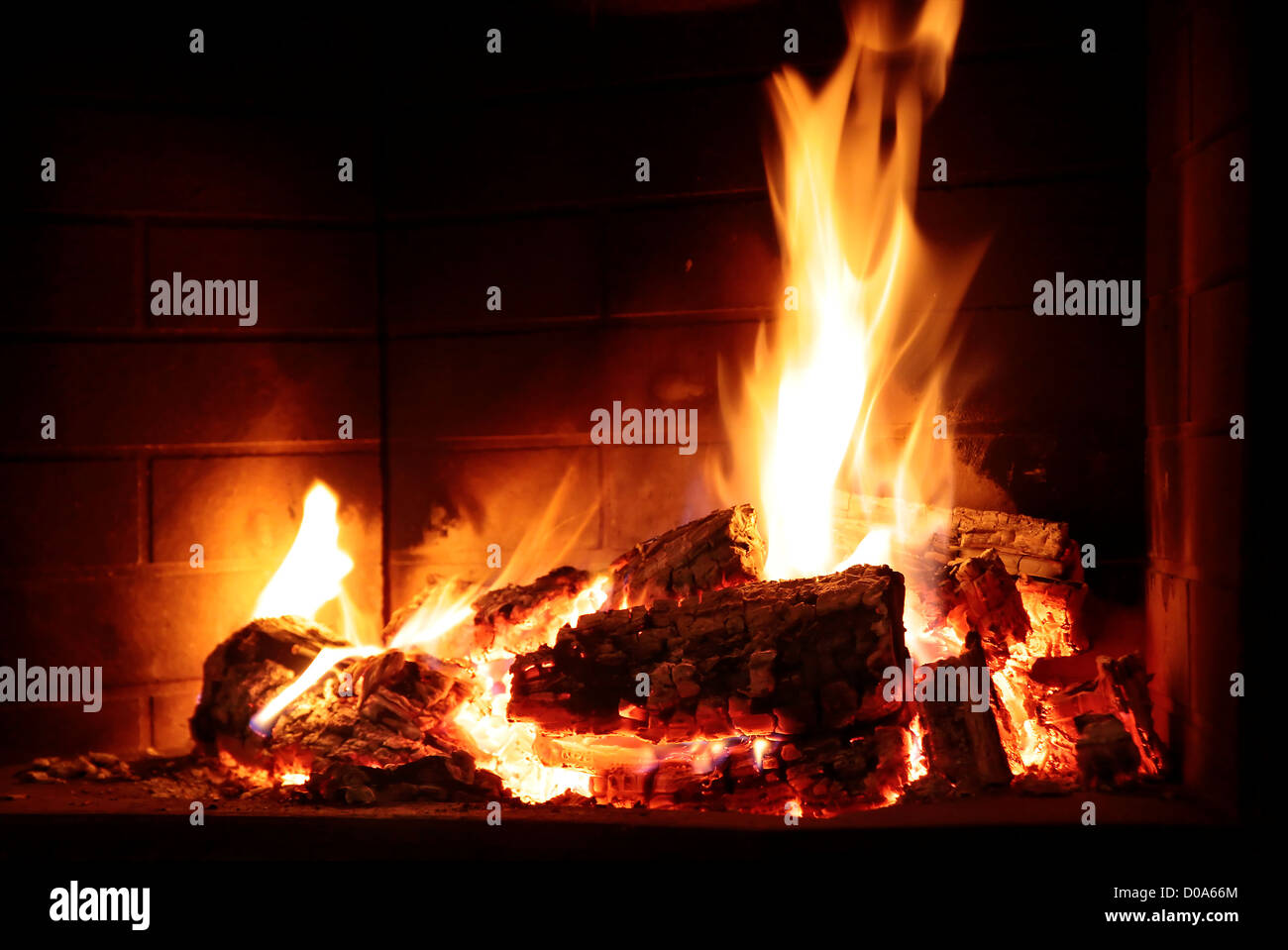 Burning fire in fireplace in country house Stock Photo