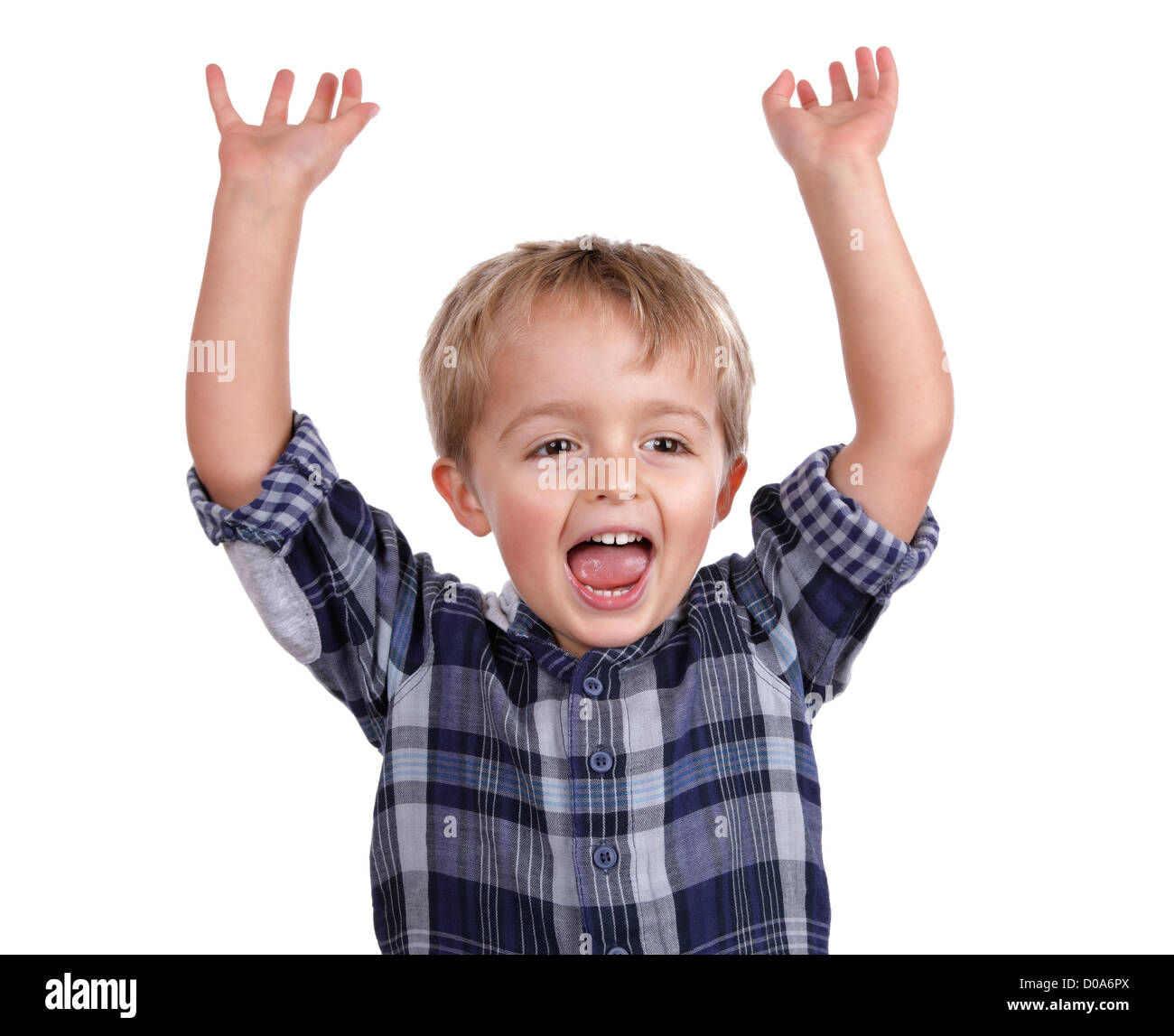 Excited boy with arms raised cheering Stock Photo