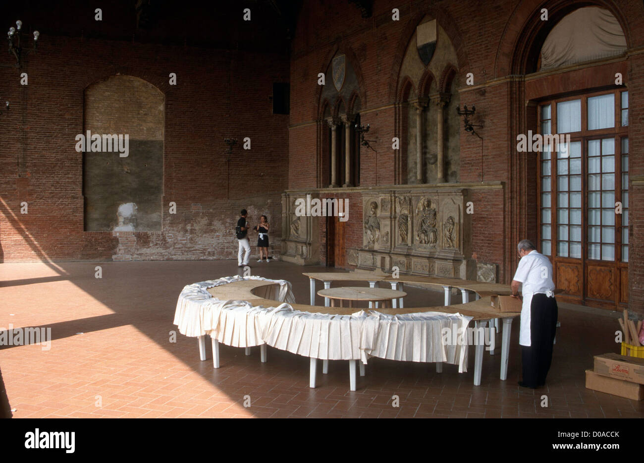 ITALY SIENA PALAZZO PUBLICA SETTING A TABLE IN THE LOGGIO Stock Photo