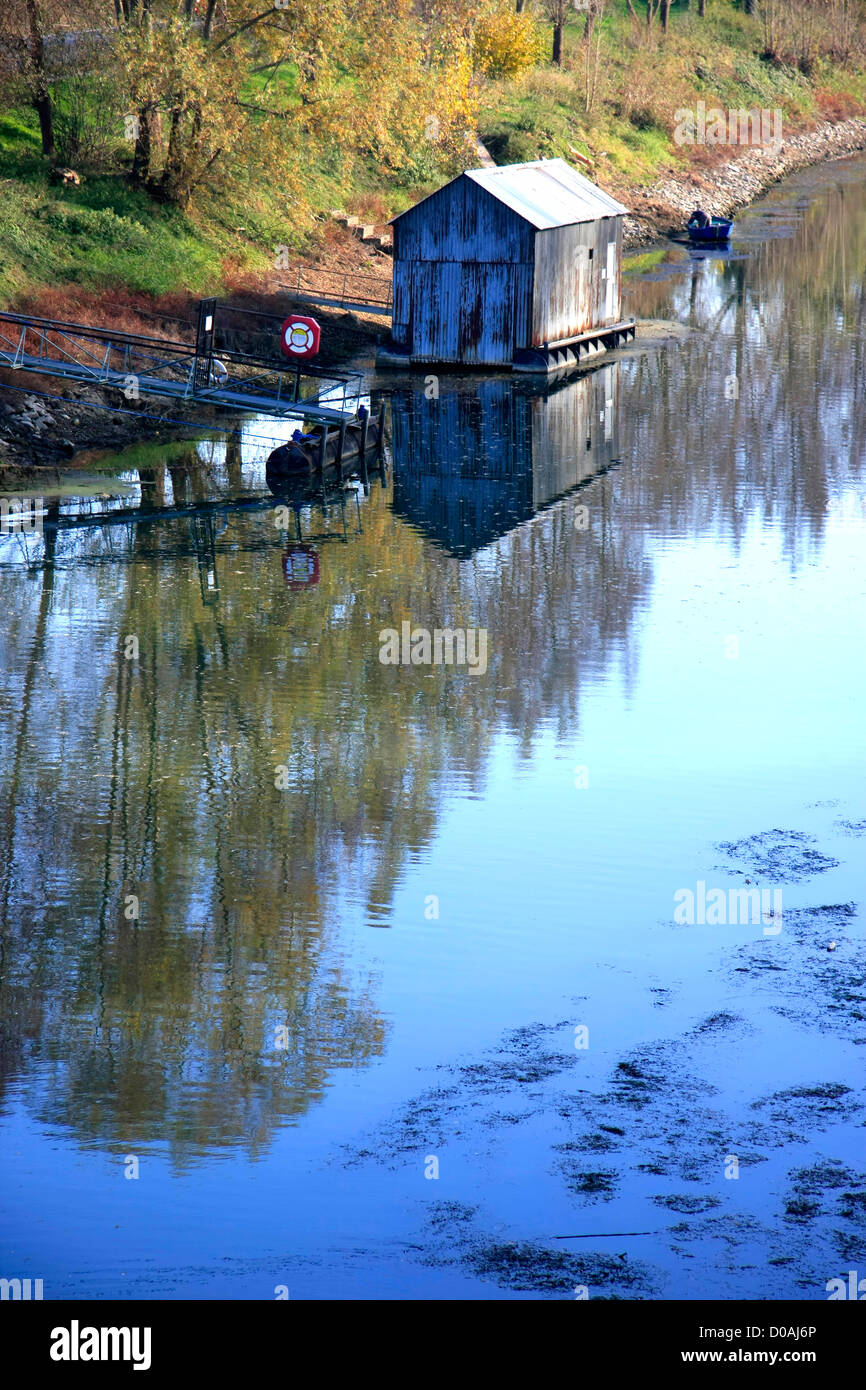 Old wooden house in the river with reflection Stock Photo - Alamy