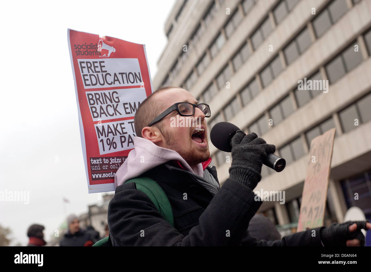London, UK - 21 November 2012: a man holds a sign from the socialist students during the march organised by the National Union of Students from Temple Place to Kennington Park to protest against tuition fees and unemployment.  © pcruciatti / Alamy  Live News Stock Photo