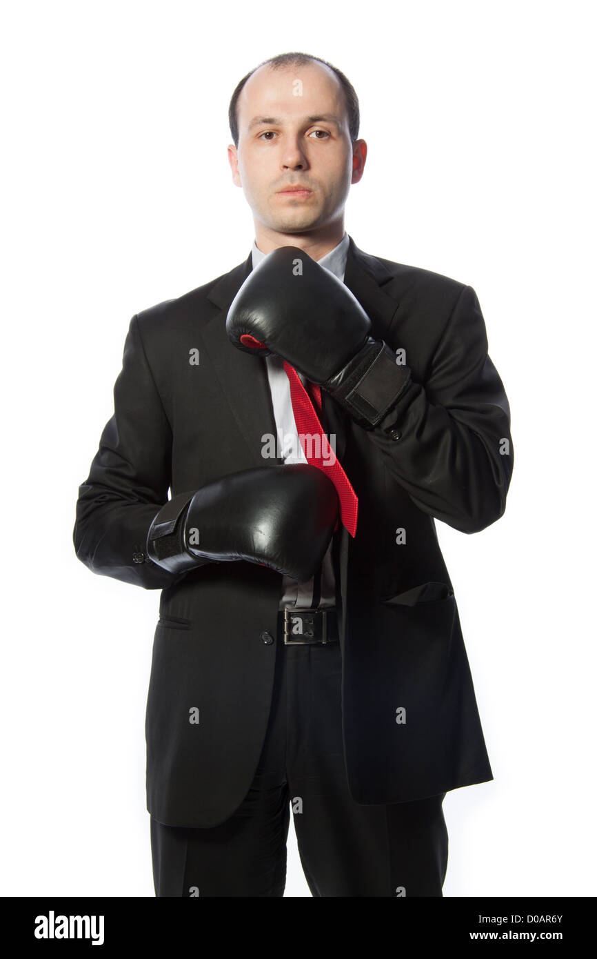 Businessman tying a tie with boxing gloves, vertical shot isolated on