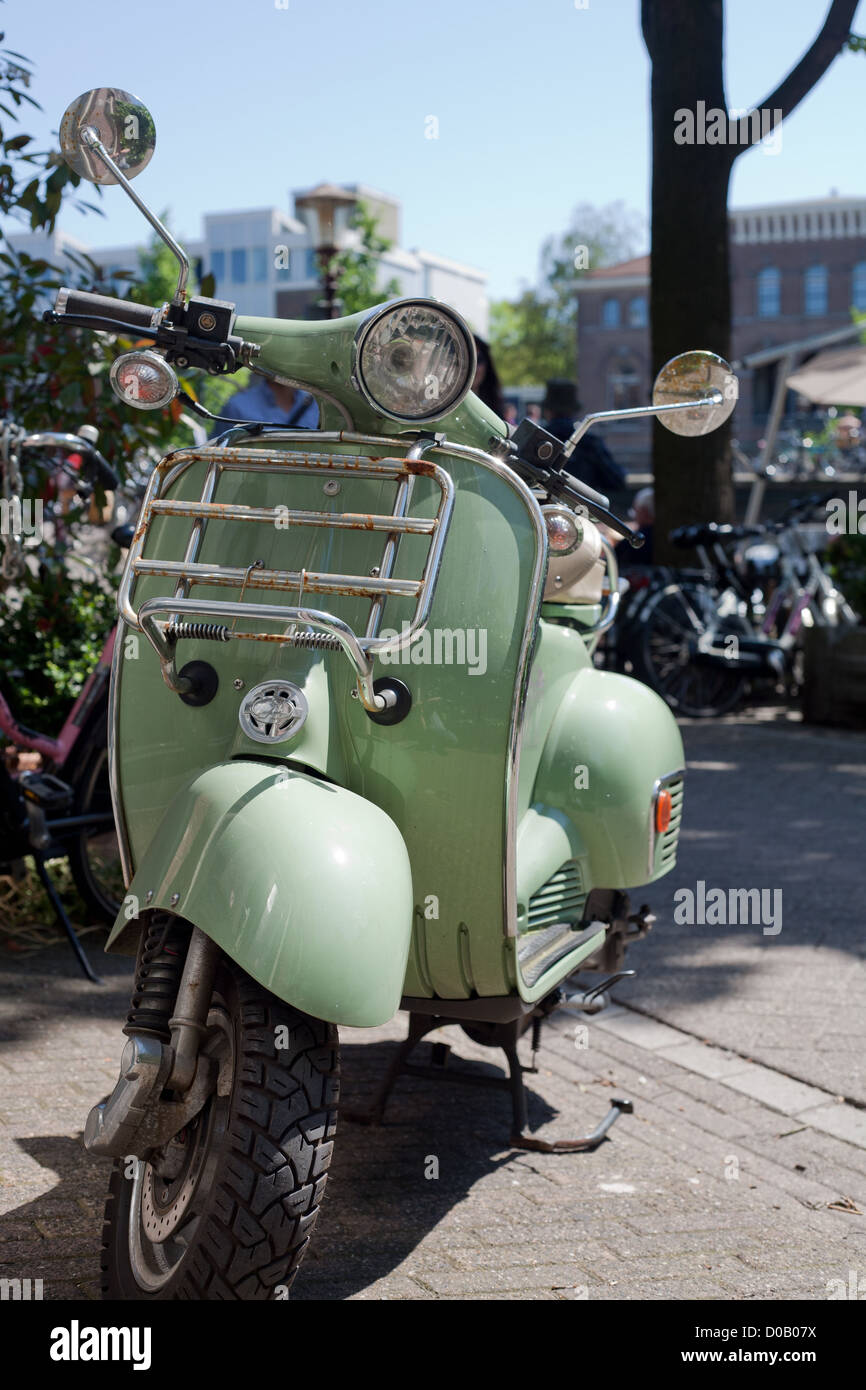 Vespa scooter parked on the sidewalk in Amsterdam Stock Photo