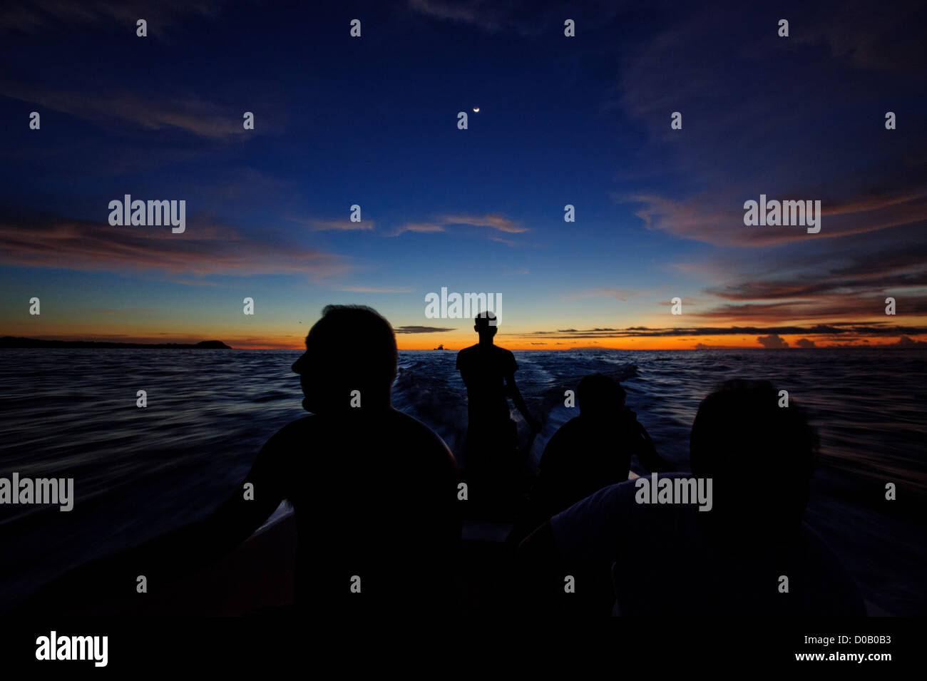 Riding a speedboat back to the island after sunset. Artistic shot. Mentawai, West Sumatra, Indonesia Stock Photo