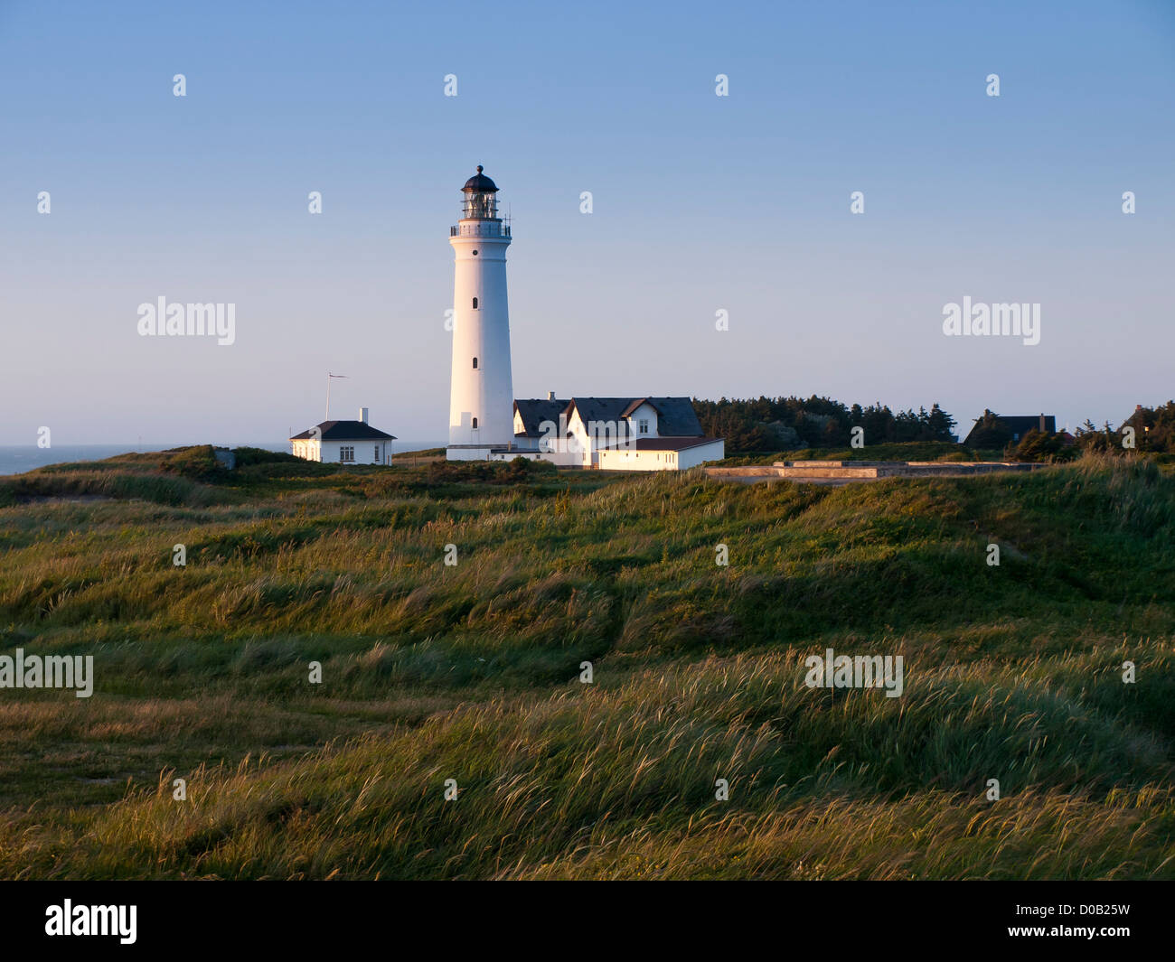late evening view of lighthouse for the ships on the North Sea, on the cliffs over the beaches in  Hirtshals Denmark Stock Photo