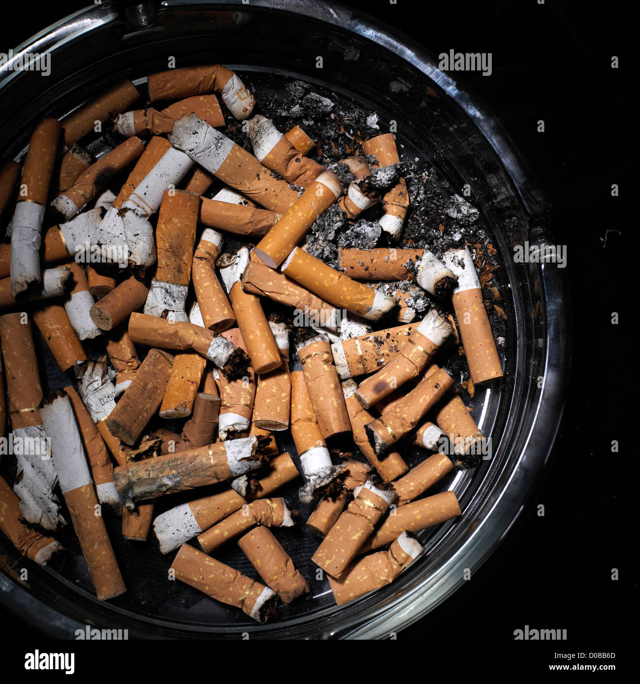 ashtray full of cigarette ends and ash Stock Photo Alamy