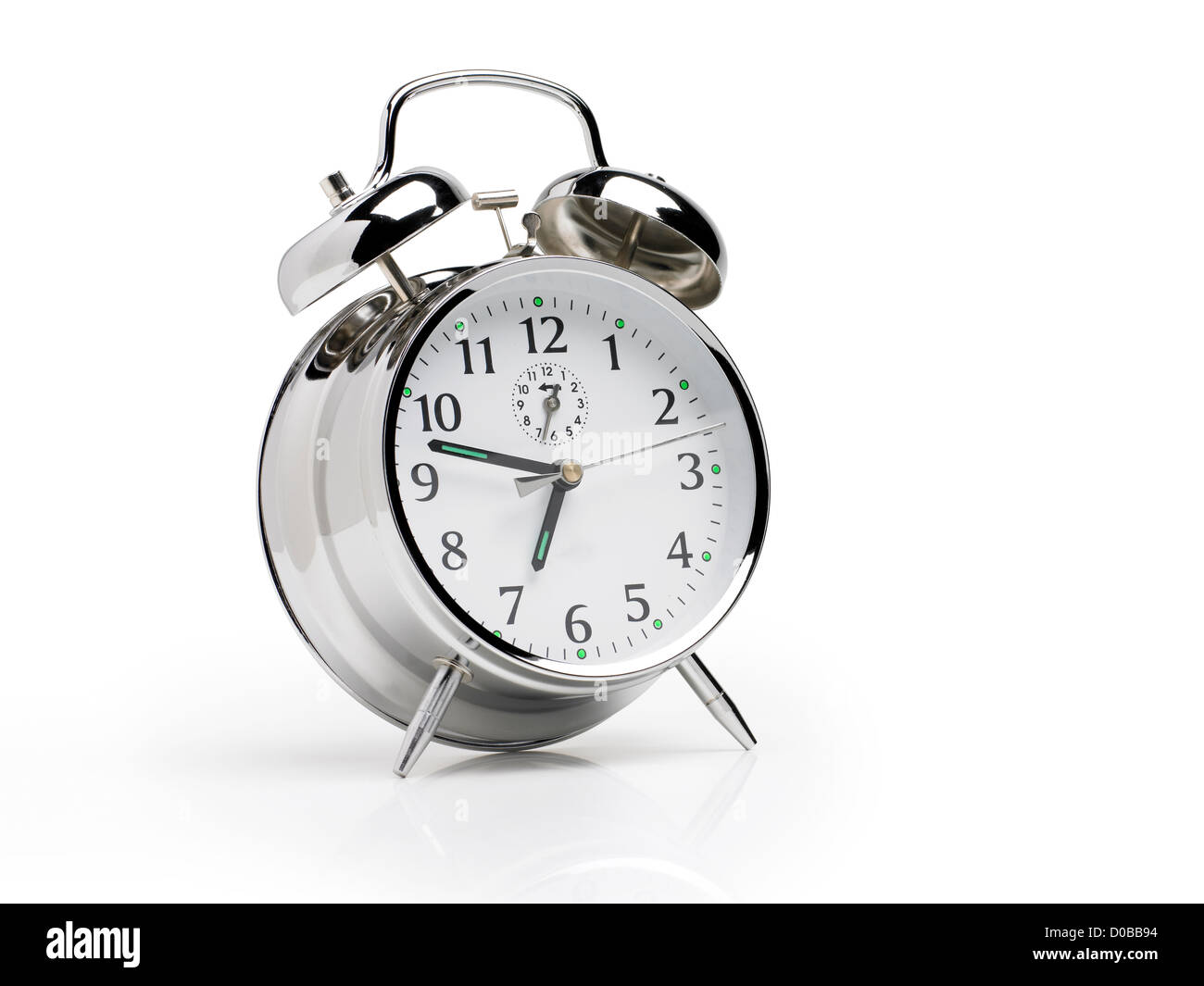 Traditional silver alarm clock on a white background with bells at six