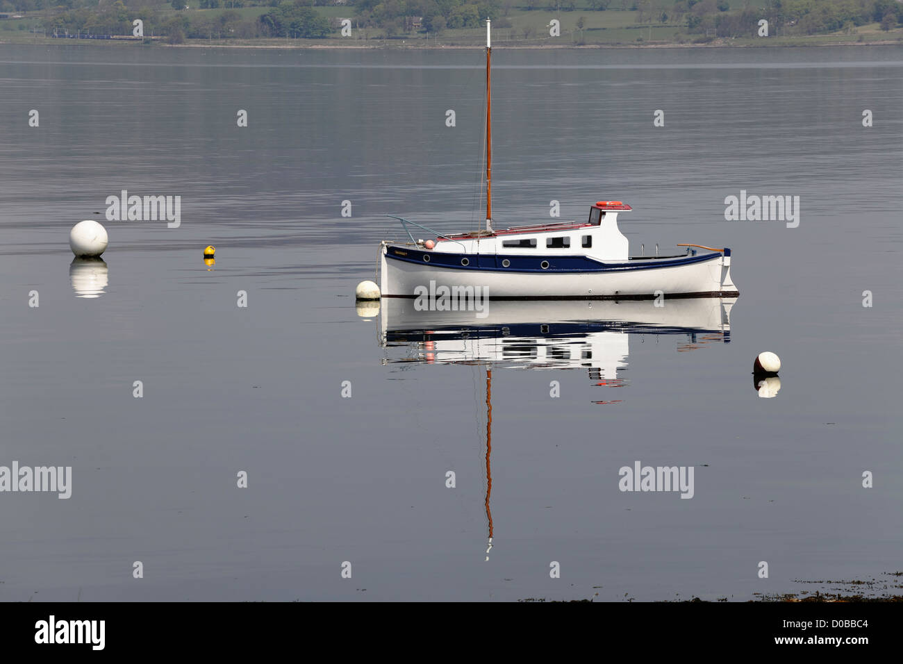 A small sailing boat moored in the Firth of Clyde at Port Glasgow in Inverclyde on the West Coast of Scotland, UK Stock Photo