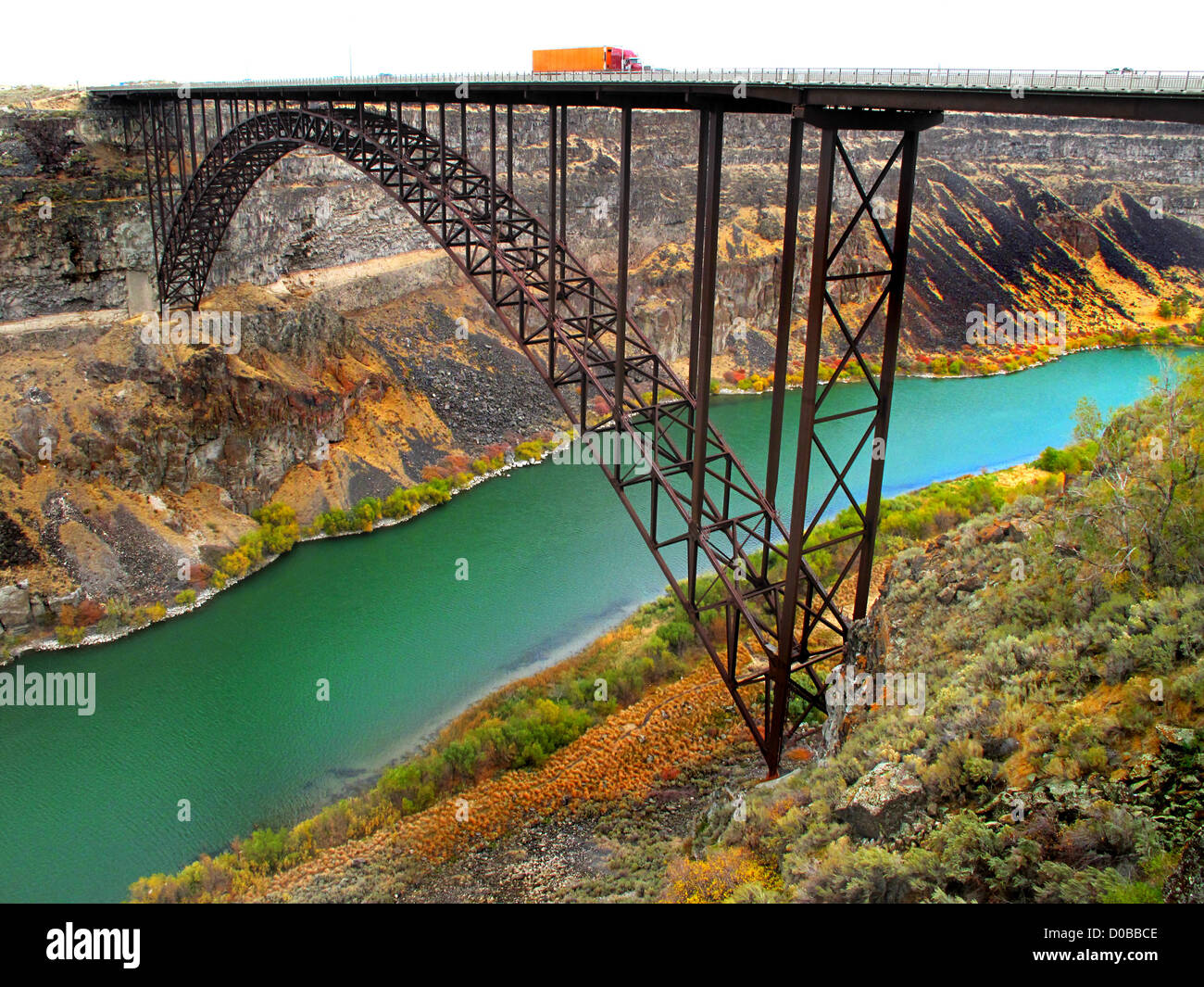 Several trucks and cars driving on long bridge Stock Photo