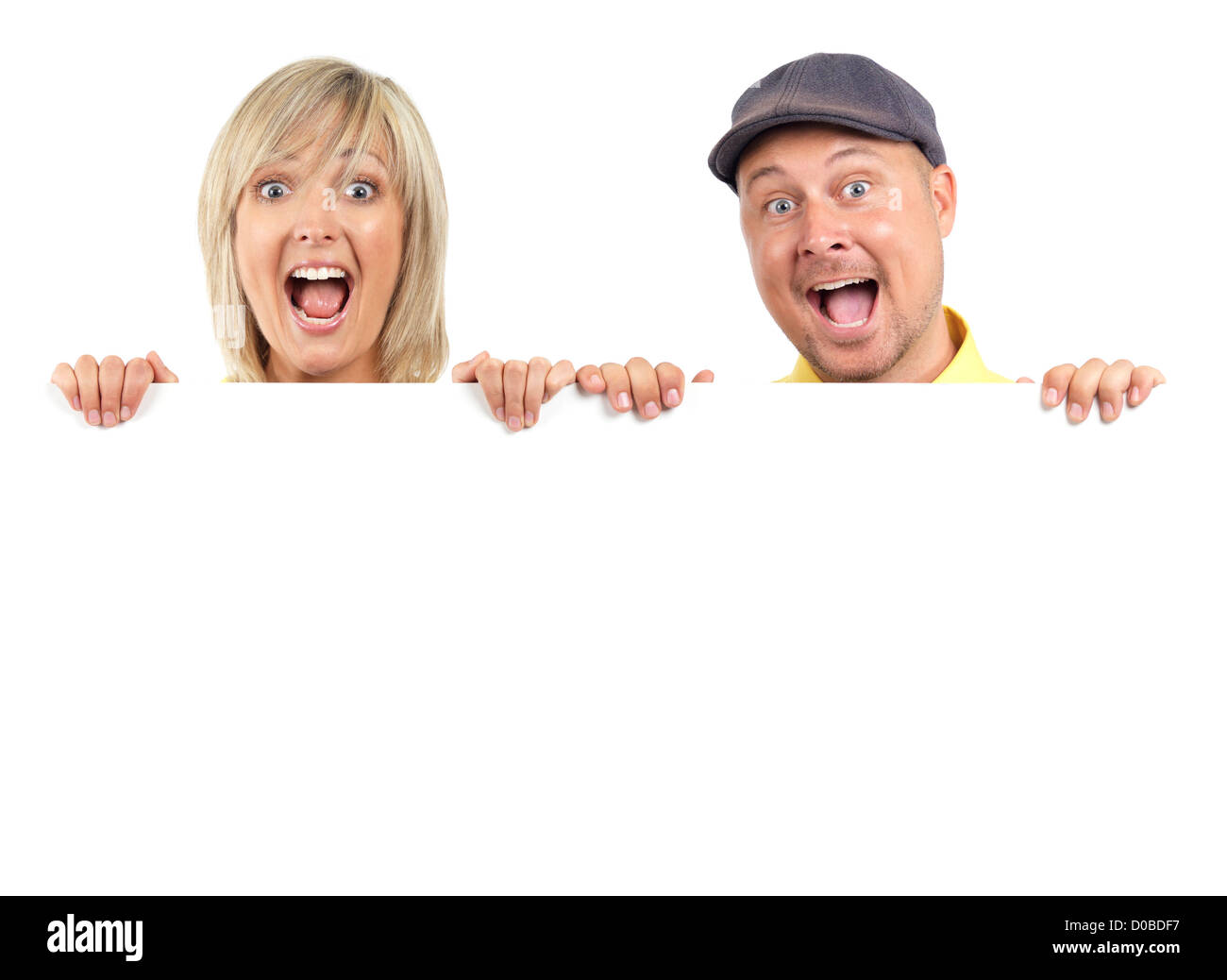 Young couple, man and woman faces with surprise scream, looking out from behind a blank white sign. Isolated on white background Stock Photo