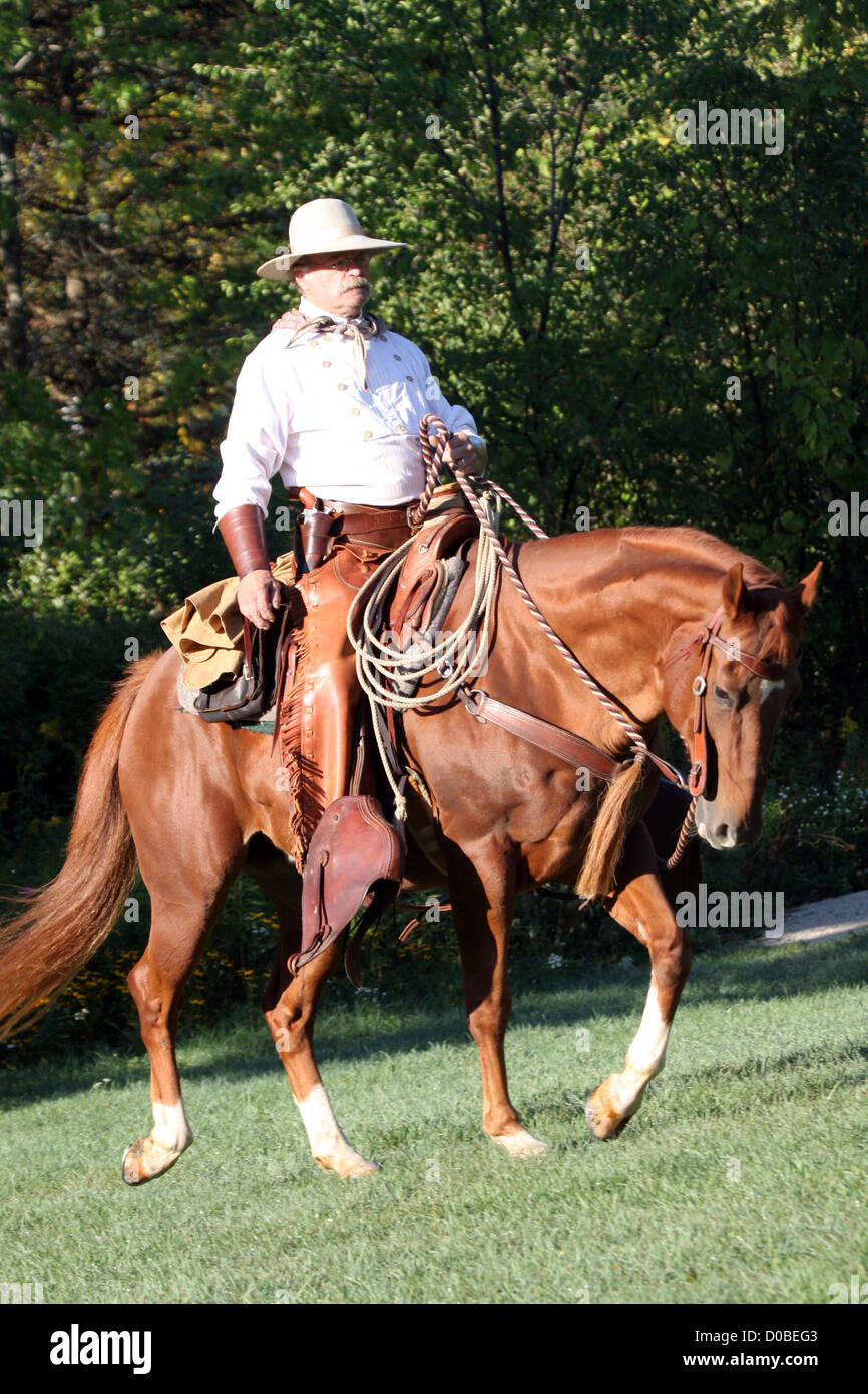 A cowboy riding horseback Stock Photo - Alamy