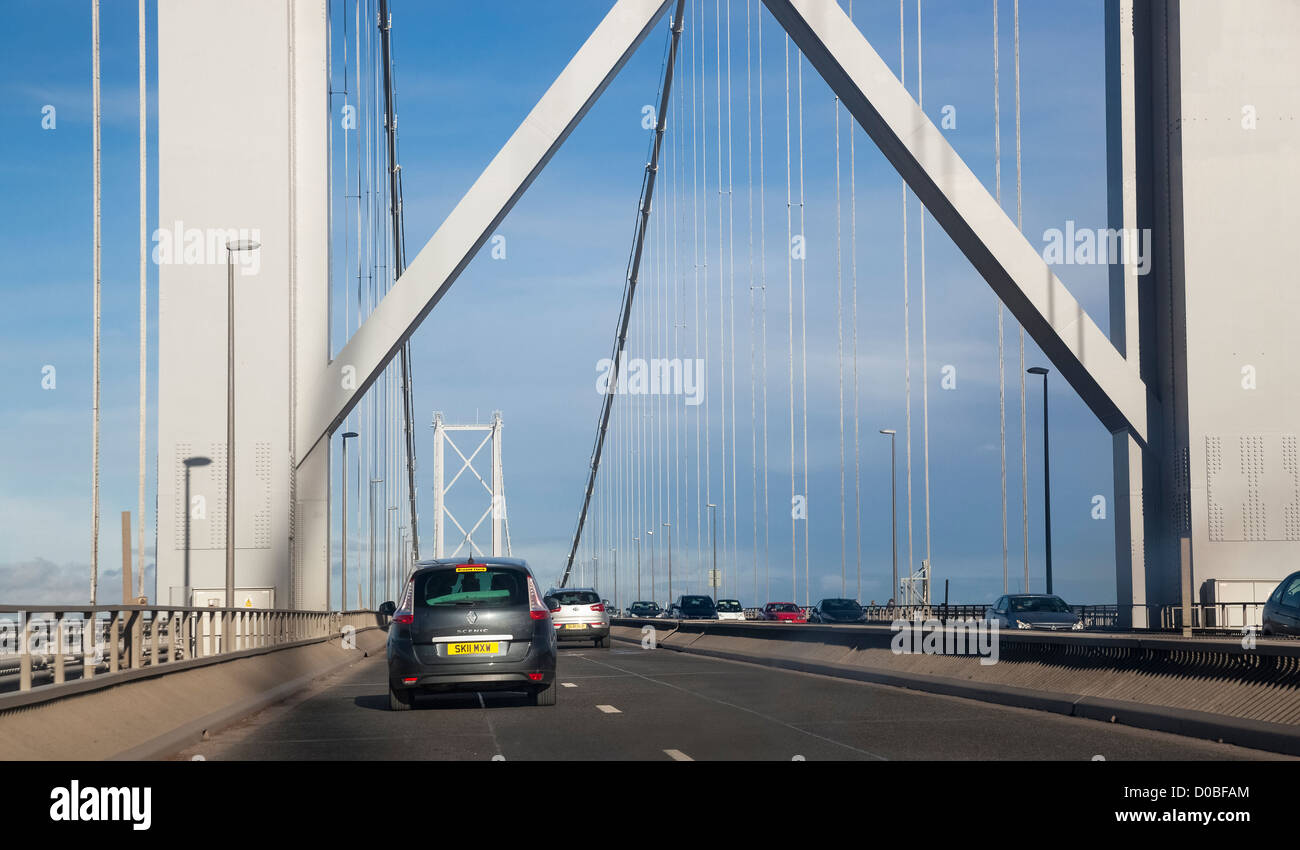 Car driving over the Forth Road Bridge on a sunny day. Stock Photo