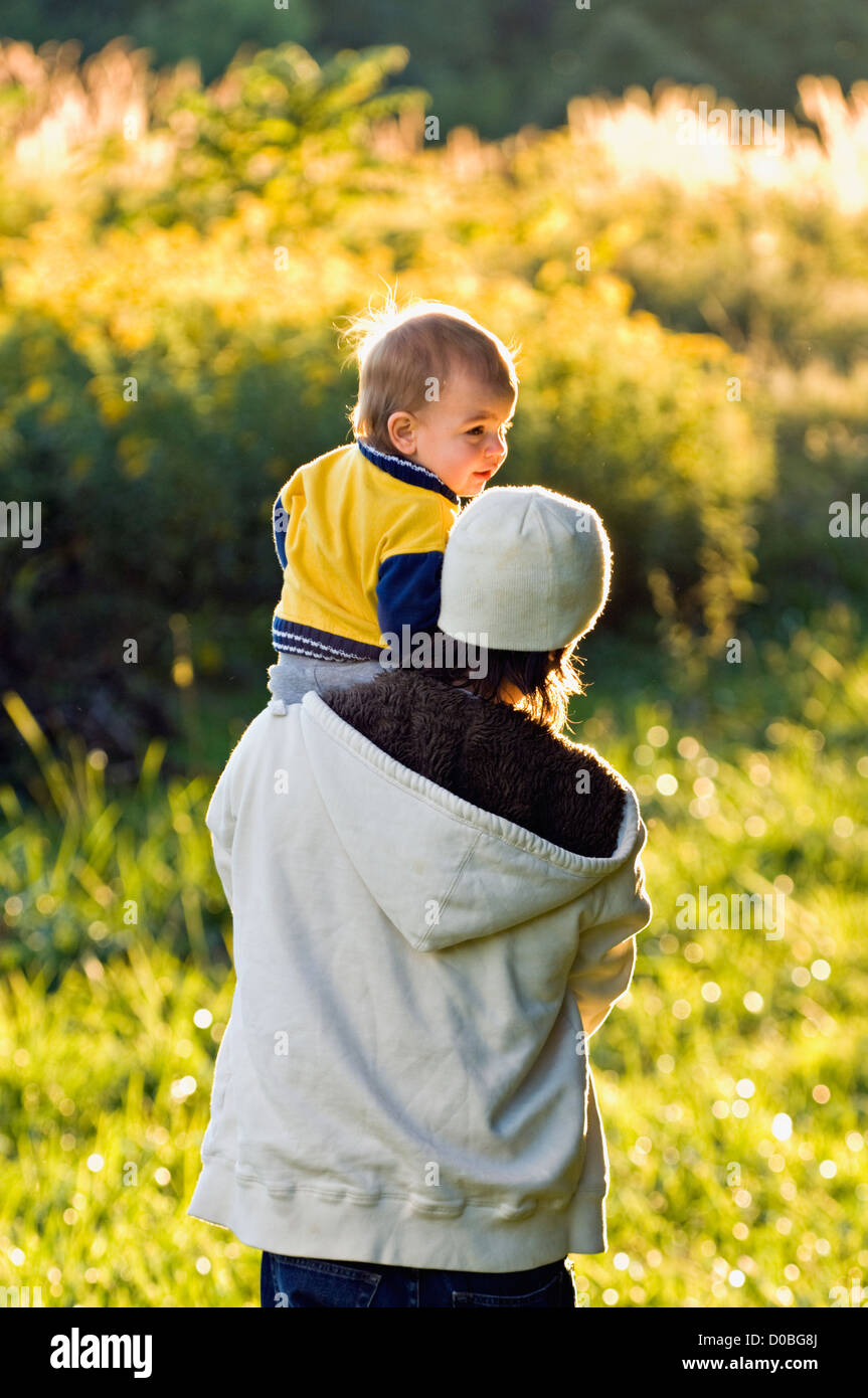Young Father Carrying Toddler while Walking through Field at Mount Saint Francis in Floyd County, Indiana Stock Photo