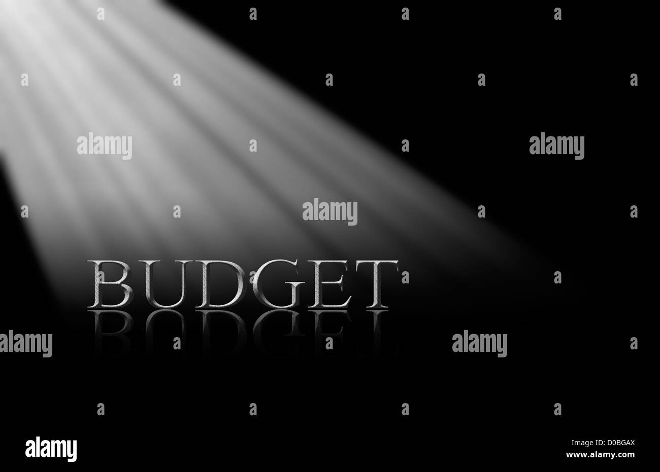 Stone lettering of the word BUDGET under a diagonal spotlight on a glossy black mirror surface Stock Photo