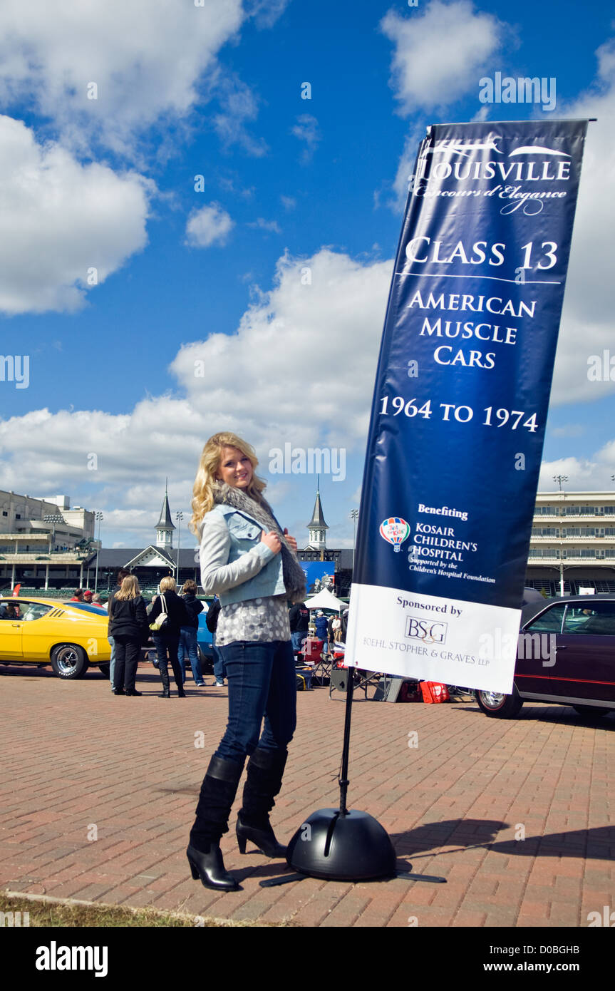 Model In 70 S Clothing Posing Beside Muscle Car Banner At The 2012