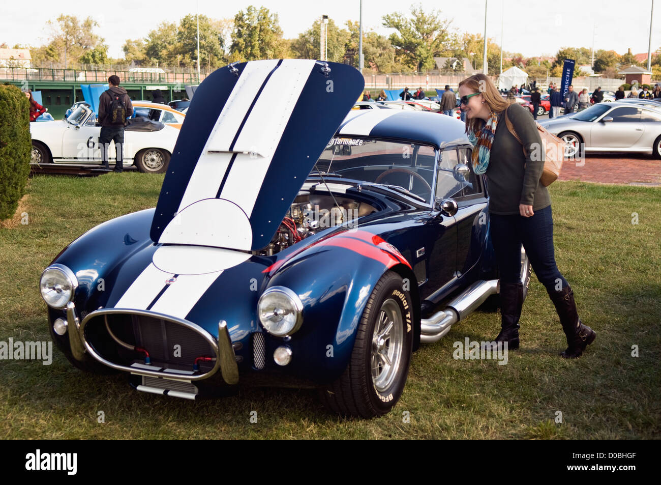 Woman Checking out a Shelby Cobra at the 2012 Concours d'Elegance at Churchill Downs in Louisville, Kentucky Stock Photo