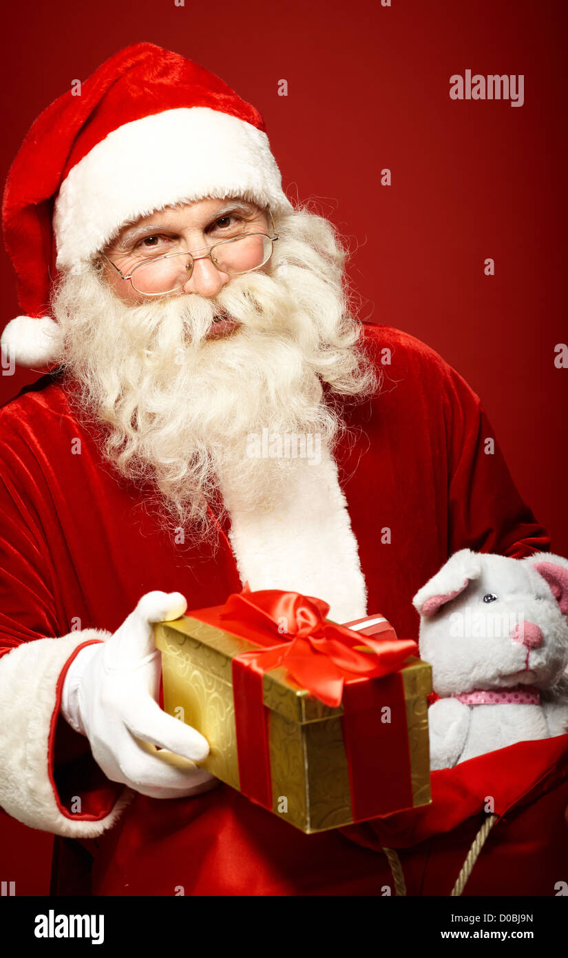 Portrait of happy Santa Claus giving Christmas present Stock Photo - Alamy