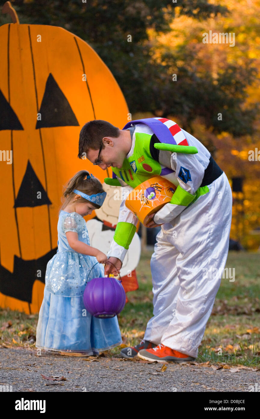 Man in Buzz Lightyear Costume Giving Candy to a Little Girl in A princess Costume during Little Goblens Galore at Iroquois Park Stock Photo