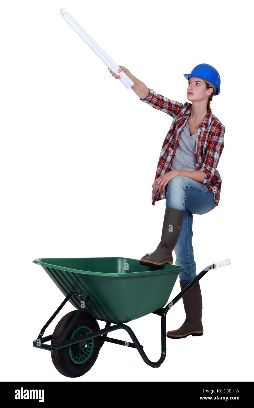 Female worker with plans and a wheelbarrow Stock Photo - Alamy