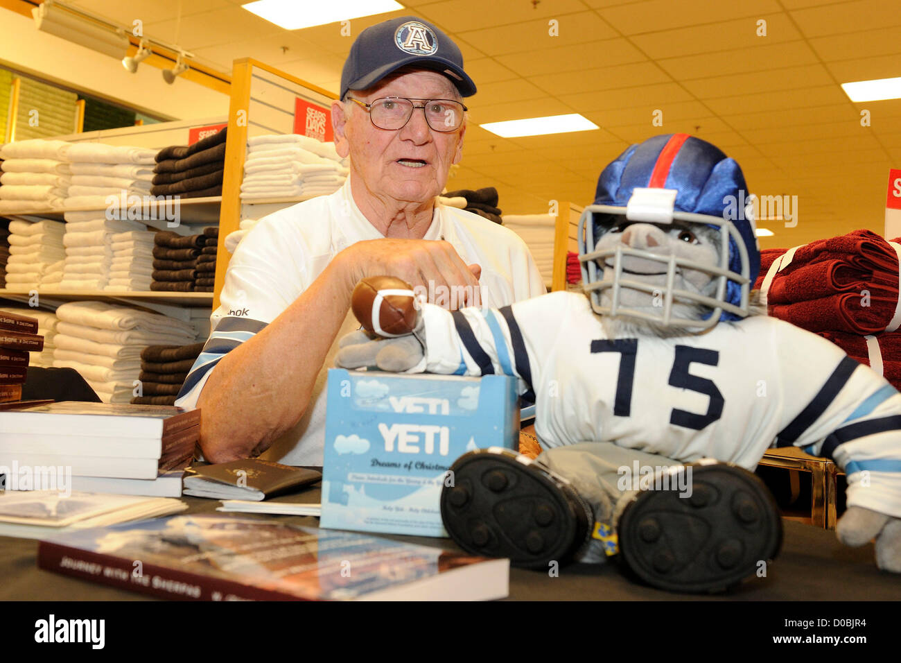 November 21, 2012. Toronto, Canada. CFL Argonauts Legend Zeke O'Connor  signs copies of his new book: Journey with the Sherpas at the Sears department store in Fairview Mall. (DCP/N8N) Stock Photo
